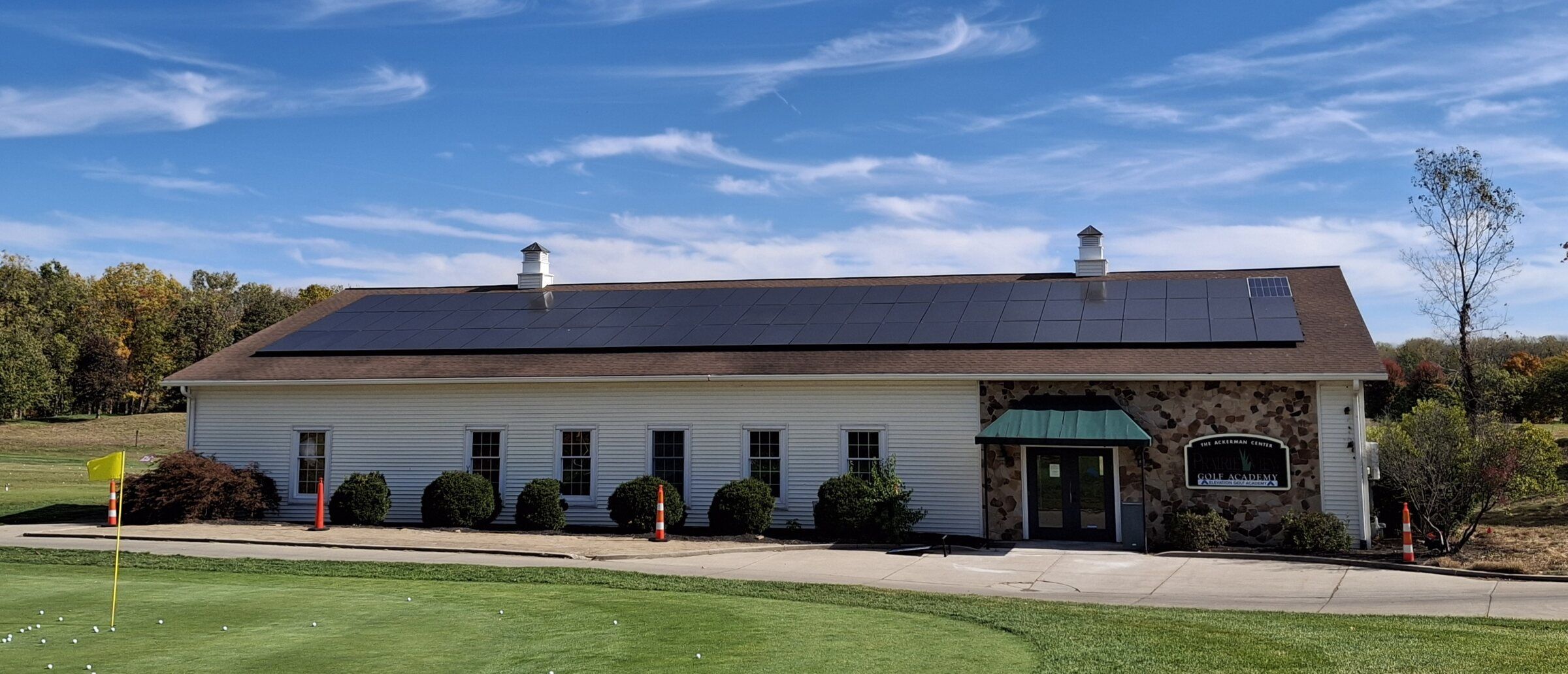 Prairie View Golf Club building with a full row of solar panels on its roof