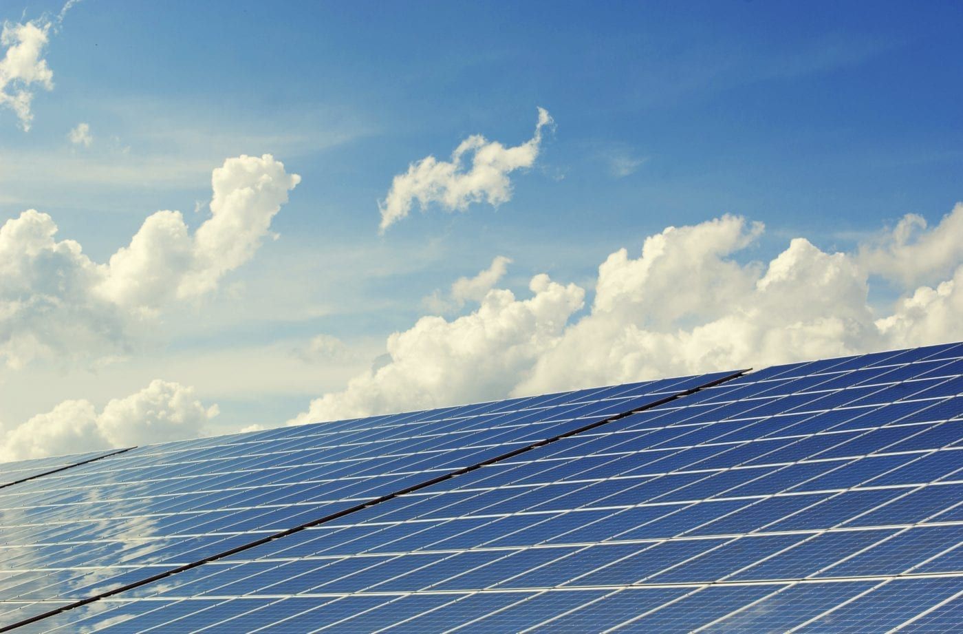 Solar panels angled toward a bright sky